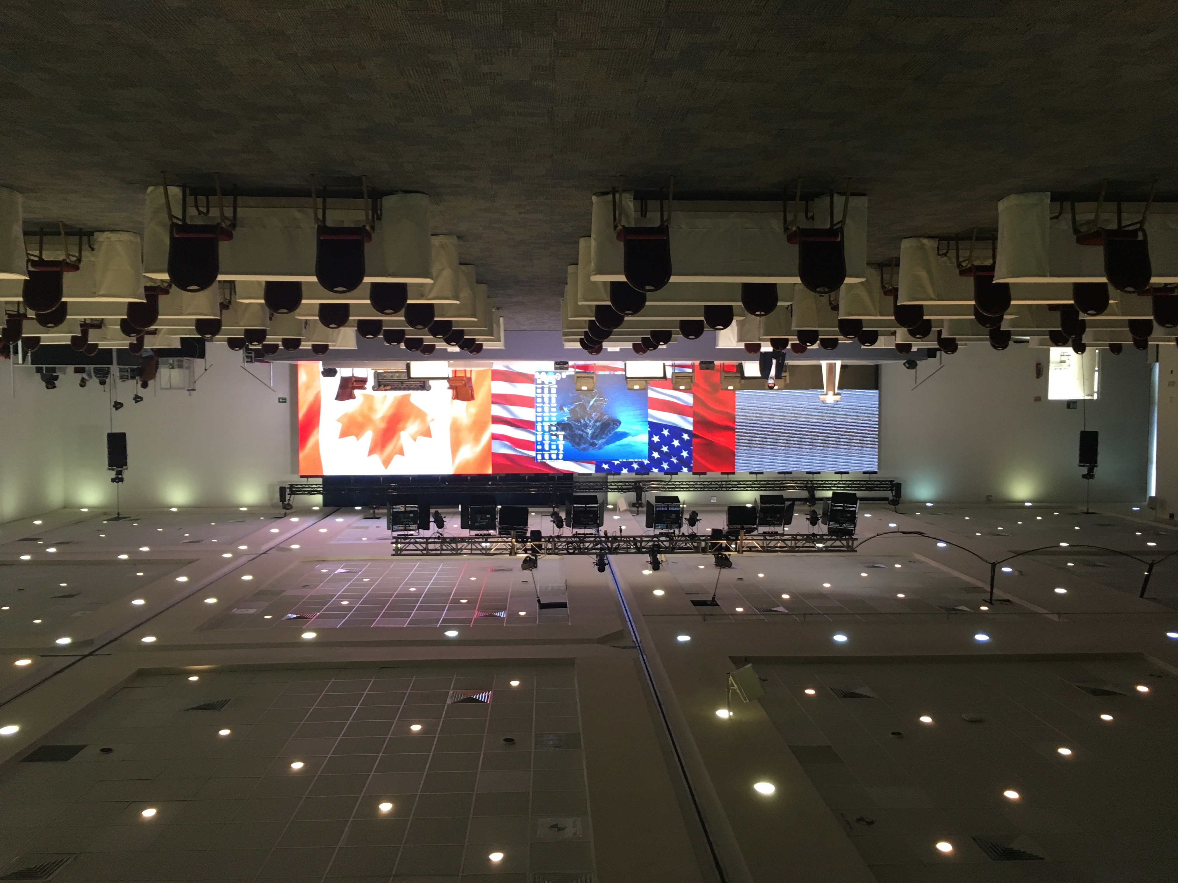 Conference stage set with U.S. and Canada flags for binational interpreted event