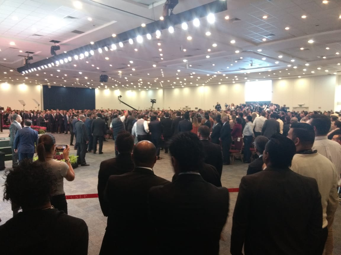 Large conference crowd at interpreted government presentation